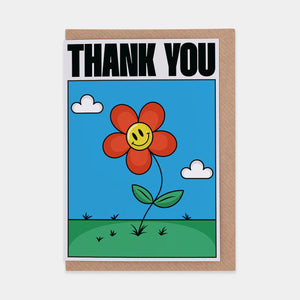 A thank you card with a red smiley flower in the center. The text on the card reads "THANK YOU"
