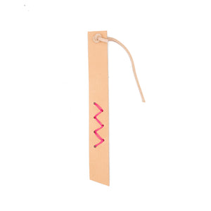 Pale pink leather bookmark with pink zig-zag stitch detail. White background.