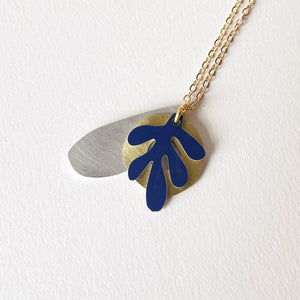 Necklace with three mixed metal shapes.