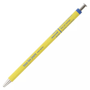 A yellow ballpoint pen with a navy cap. The pen has French text printed on it.