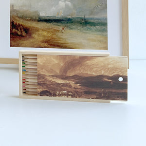 Wooden box for a pencil set featuring a landscape drawing by JMW Turner in front of a framed Turner print reproduction