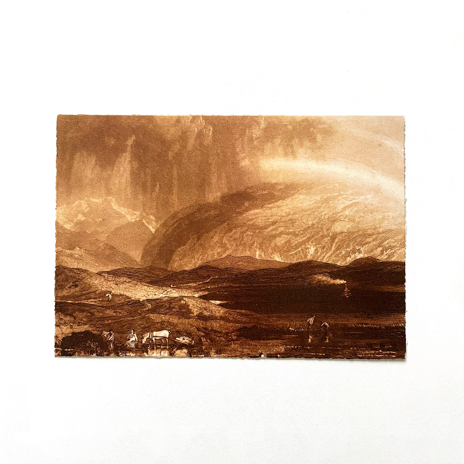 Print with torn edges depicting J.M.W Turner seascape drawing of hills and the sky.