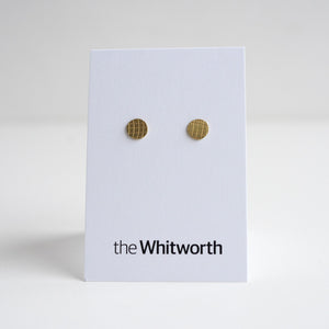 This image shows pair of stud earrings with grid-pattern etching displayed on a white card.