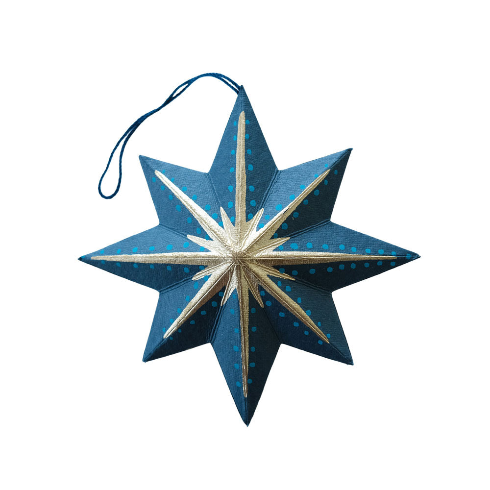 Blue star-shaped ornament with gold accents on a white background