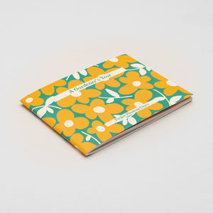 A6 diary with a yellow and green floral print on the front cover, photographed against a white background.