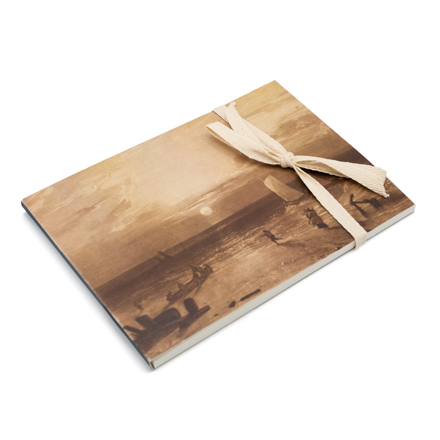 A5 sketchpad with a ribbon tied around it. The front cover features a Turner seascape drawing.