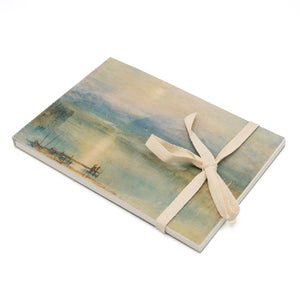 A5 sketchpad with a ribbon tied around it. The front cover depicts a seascape watercolour by Turner