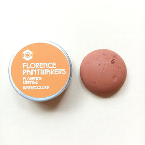 The image shows a small tin of Florence Printmakers Florence Orange watercolour paint.