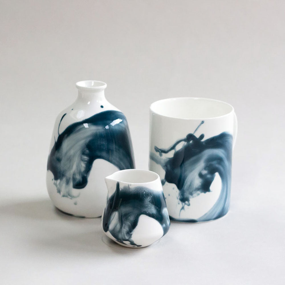 Three white ceramic items with blue wash pattern, photographed in front of a white background