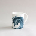 White ceramic vase with blue wash pattern photographed in front of a white background