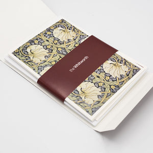 The greetings card pack revealing the cards inside wrapped with a maroon Whitworth-branded belly band.
