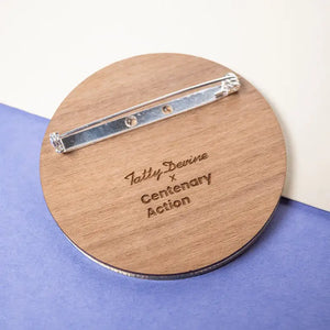 Reverse of brooch with Tatty Devine x Centenary Action Logo