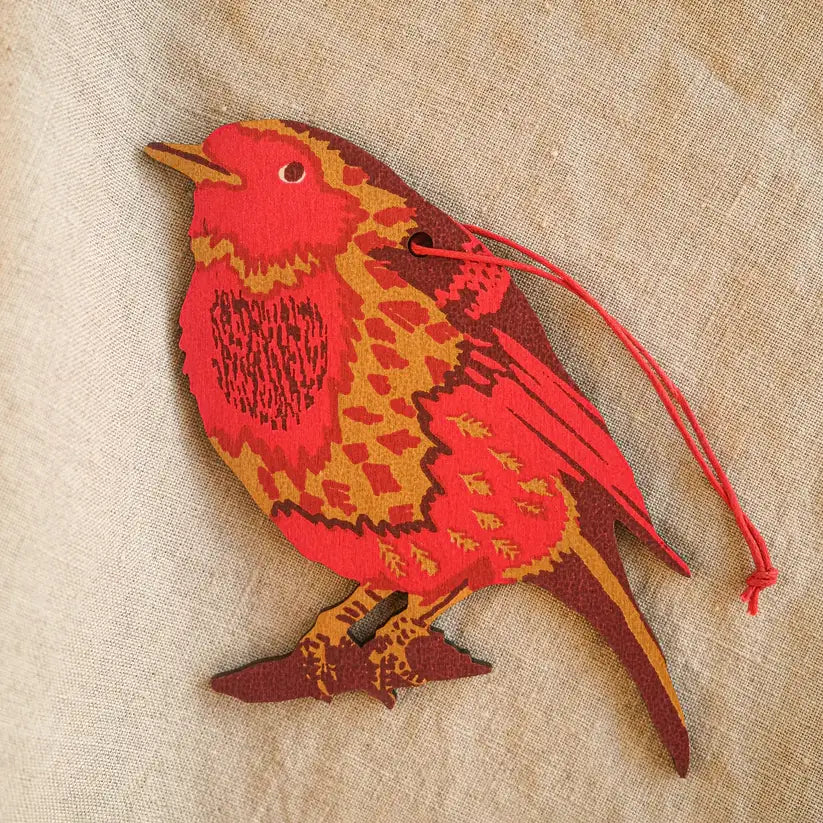 A photo of a hand-painted wooden Christmas ornament shaped like a robin bird. The robin is primarily red with brown accents and has a small string attached for hanging.