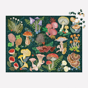 A jigsaw puzzle depicting a variety of colourful mushrooms arranged against a dark green background. The mushrooms are illustrated in a detailed, botanical style, with some showing their caps, stems, and roots. Smaller plants and flowers are also included in the design. A few puzzle pieces are missing from the bottom right corner.