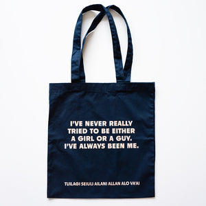 Navy blue tote bag with white text on a white background