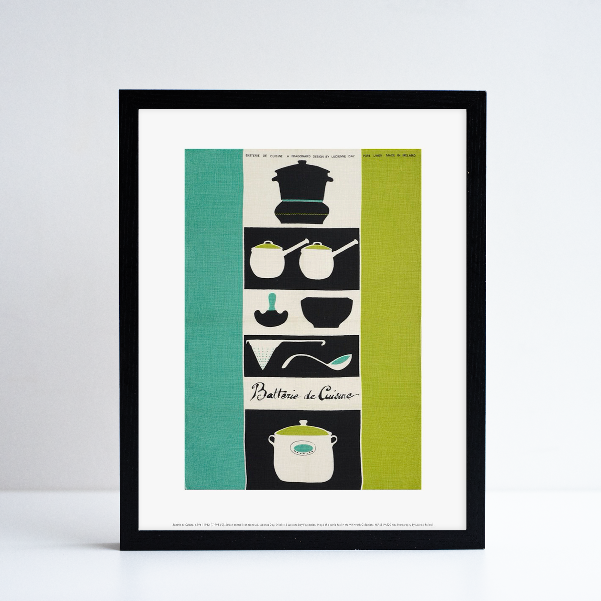 Framed reproduction of Batterie de Cuisine by Lucienne Day. A green, black and white print with Kitchenware at the centre.