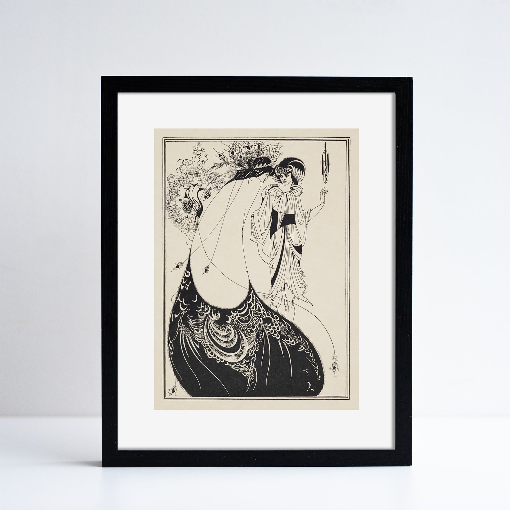 Framed print of Aubrey Beardsley The Peacock Skirt repriduction. Black and cream drawing of two figures in extravagant clothing. White background.
