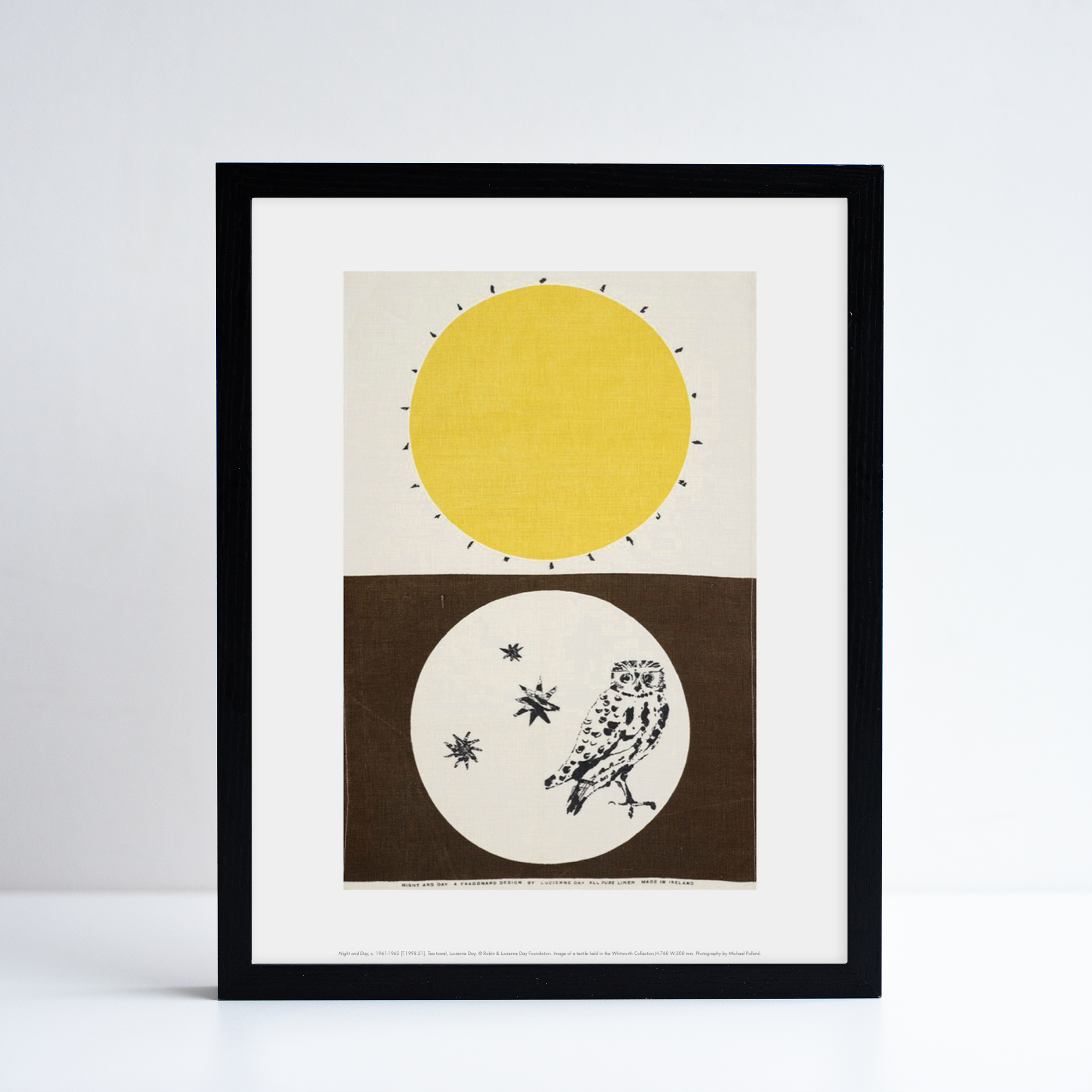 Framed reproduction of Night and Day by Lucienne day. The print has a owl at the bottom half and a sun at the top.