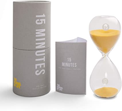 Image of a timer with grey cylinder packaging to its left.