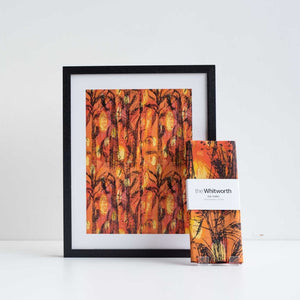 Black framed print and tea towel featuring orange Golden Harvest design by Althea McNish against a white background.