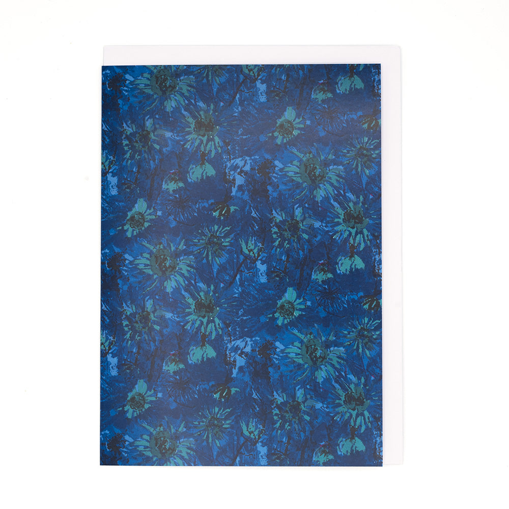 Straight on view of the caribe artwork card with a white envelope. Flowery patterns in blue are the main subject of the artwork.