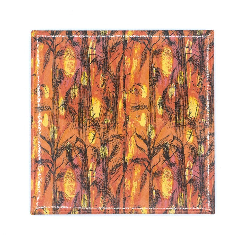 The Golden Harvest artwork as a square magnet on a white background. The primary colours of the print is orange, reds and yellows with black trees.