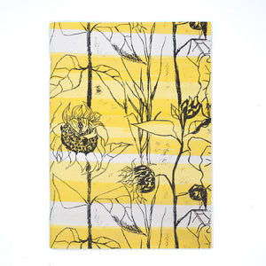 Image of a rectangular notebook, the cover is Althea McNishs textile design Van Gogh. White backdrop.