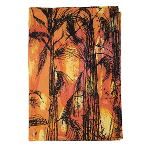 The tea towel with the golden harvest artwork folded and seen against a white background.