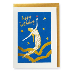 Card, gold envelope. Blue and gold print with a robed, golden haired figure raising a glass with a red liquid. Text reads happy birthday.
