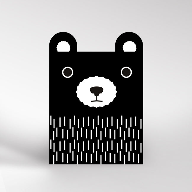 Black and white card with bear ears cutout at the top. The bear is black with a white muzzle and white line detail for fur on the body.
