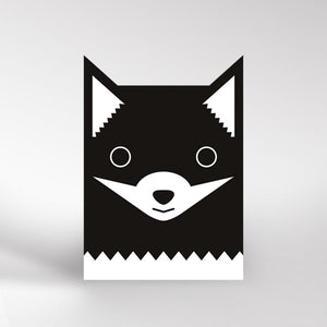 Black and white card with fox ears cutout at the top. The black fox is black white a white muzzle and white at the bottom of the card.