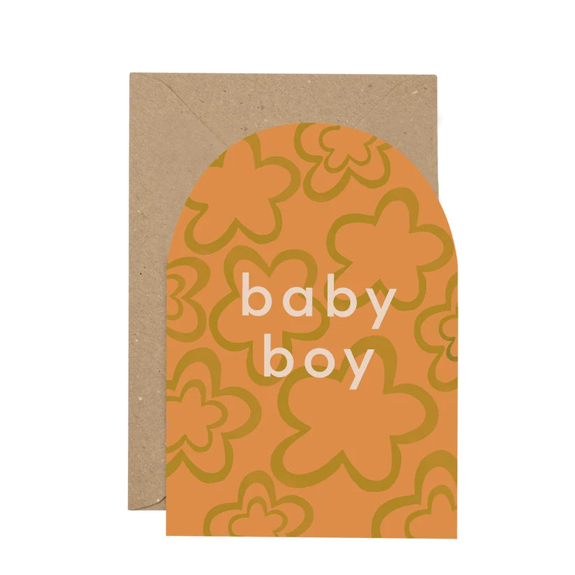 Arch shapes card with the words Baby Boy written in white font at the centre. The card is orange with green flower print. Brown envelope. White background.