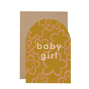 Arch shapes card with the words Baby Boy written in white font at the centre. The card is orange with green flower print. Brown envelope. White background.