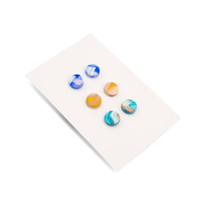 3 sets of earrings made in a marble pattern in Polymer clay. Photographed on white backing card against a white background.