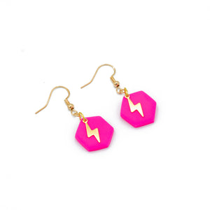Pink hexagonal earrings with a brass lightening bolt and brass fittings
