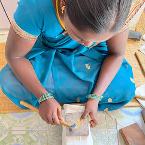A woman hammering the earring. Photo credit Just Trade