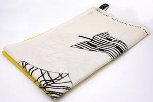 Image of tea towel folded in to 1/4. White and yellow design with black leaf detail. Text reading 'twentytwentyone, made in ireland'