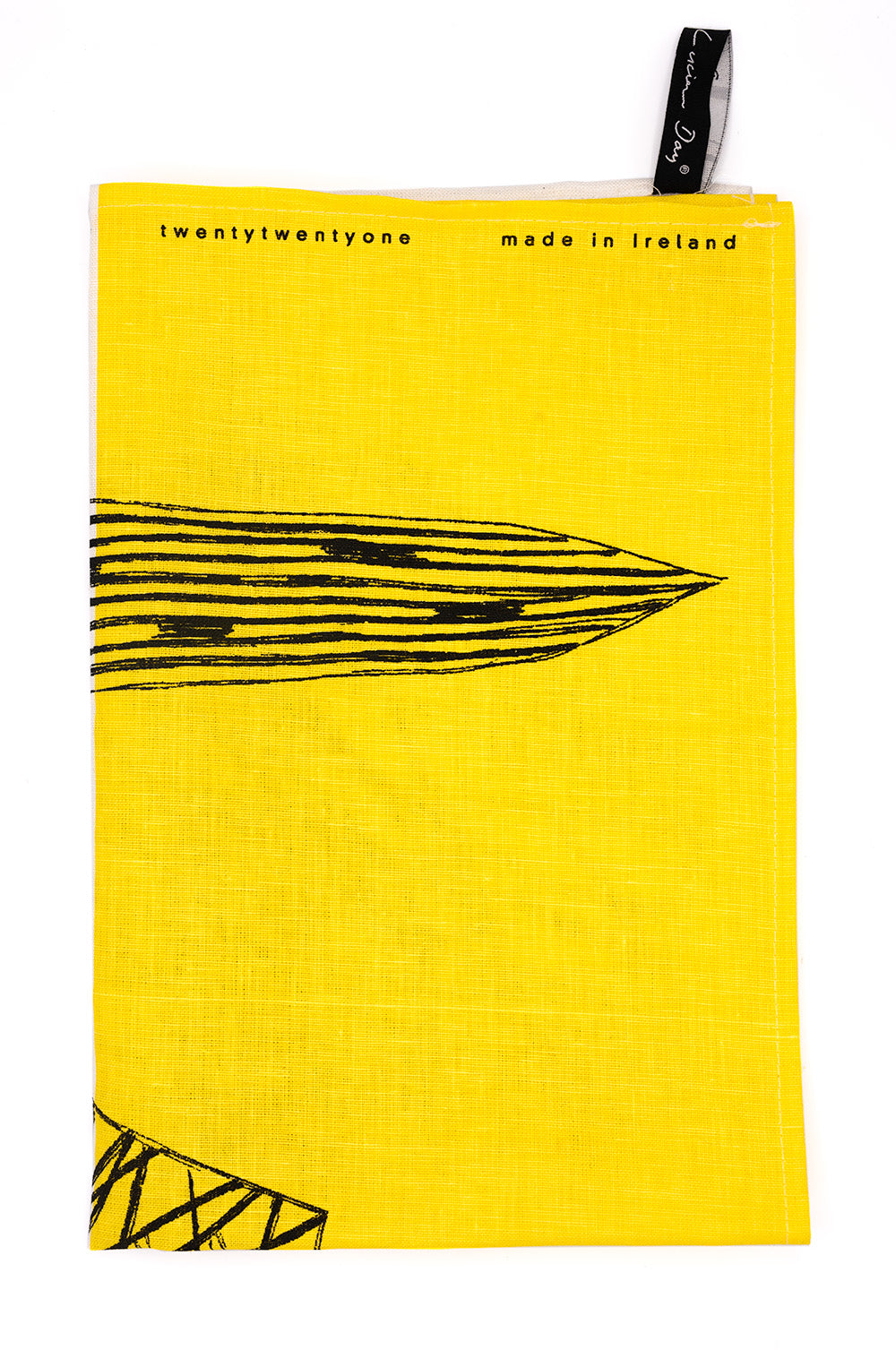 Image of tea towel folded in to 1/4. Yellow design with black leaf detail. Text reading 'twentytwentyone, made in ireland'