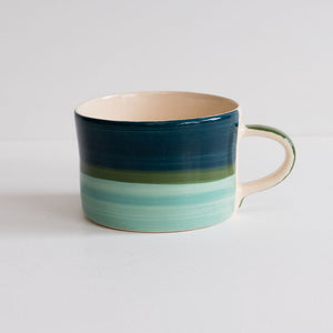 Image of a blue striped mug against light grey background