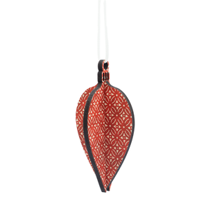 Oval bauble decoration against white background. Scandi red finish on the decoration.