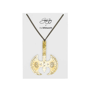 Gold Labrys pendant necklace against a white backdrop. Card backing.
