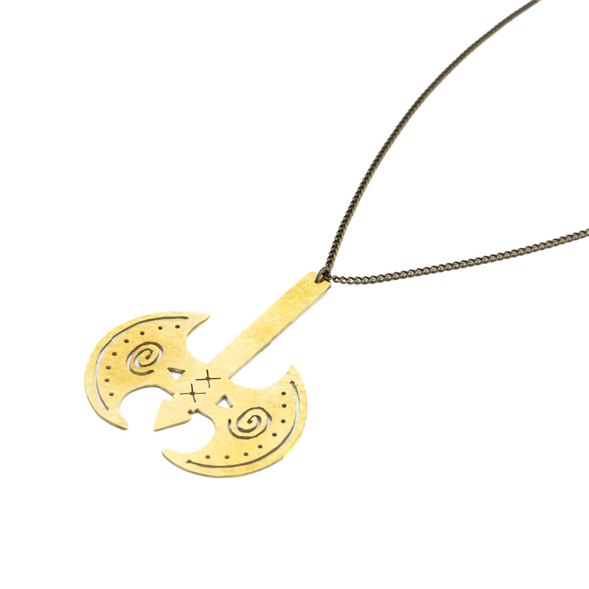 Gold Labrys pendant necklace against a white backdrop.