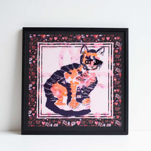 Square embroidery of a cat, framed