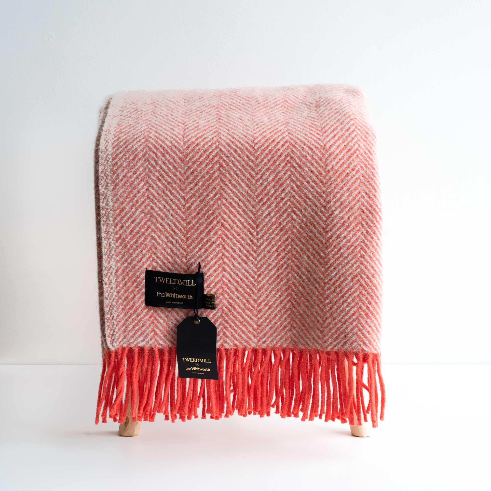 Image of a red woollen blanket on a stool - white background