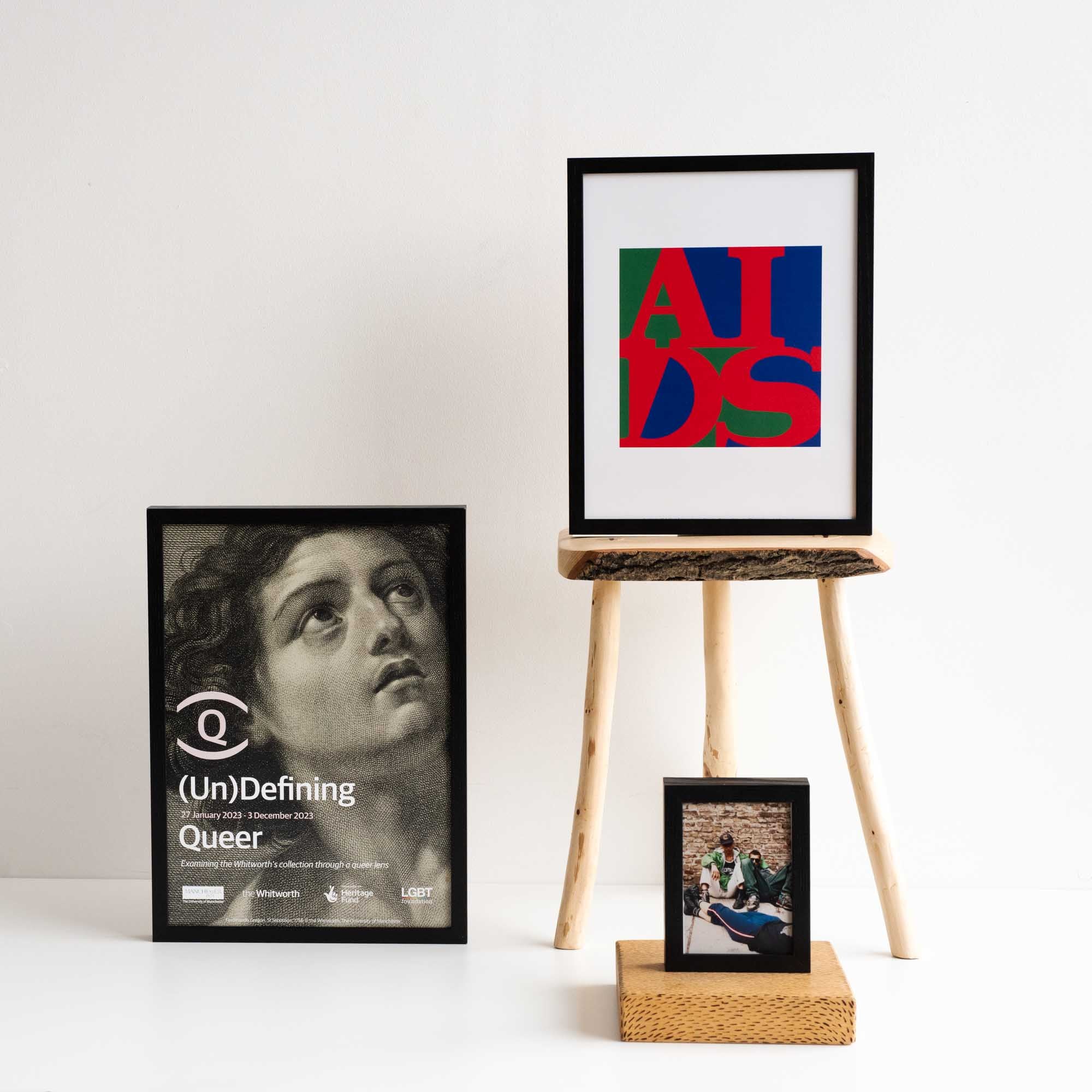 I photo of three framed works in front of a white background
