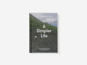Image of a book. The cover is a photograph of a forest with white words 'A Simpler Life' overlaid.