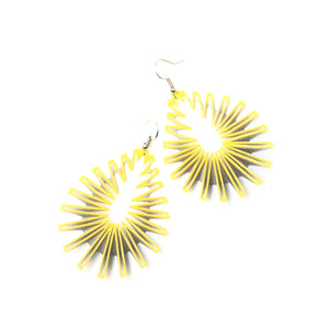 A pair of zigzag 3d printed earrings on white background.