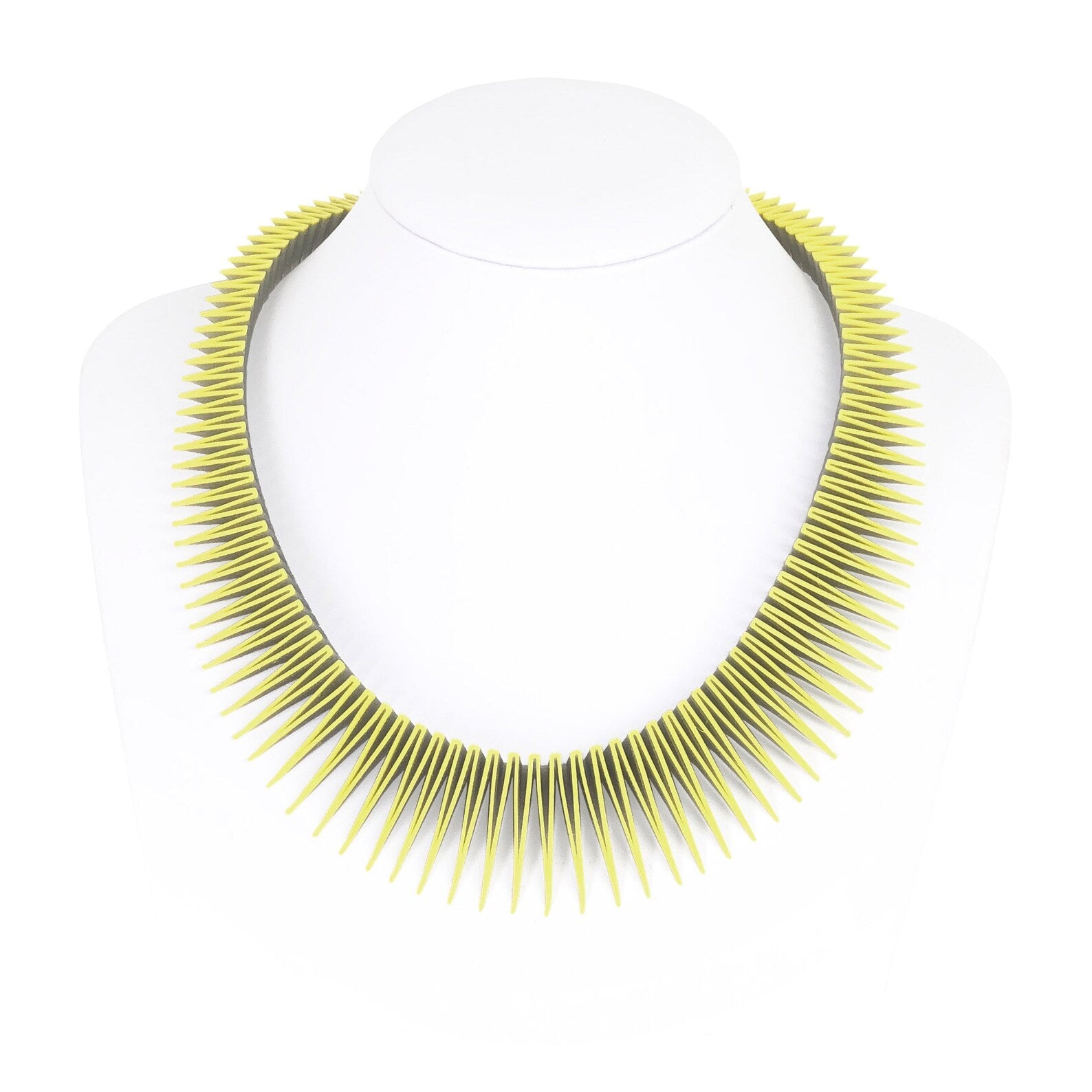 The zigzag 3d printed necklace on a white necklace stand.