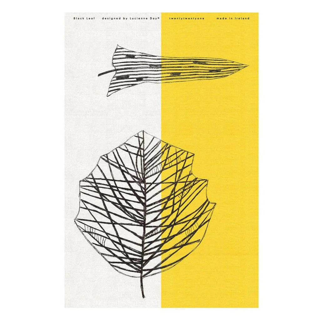 Image of Lucienne Day 'Black Leaf' tea towel design. Yellow and white with two black leaves.